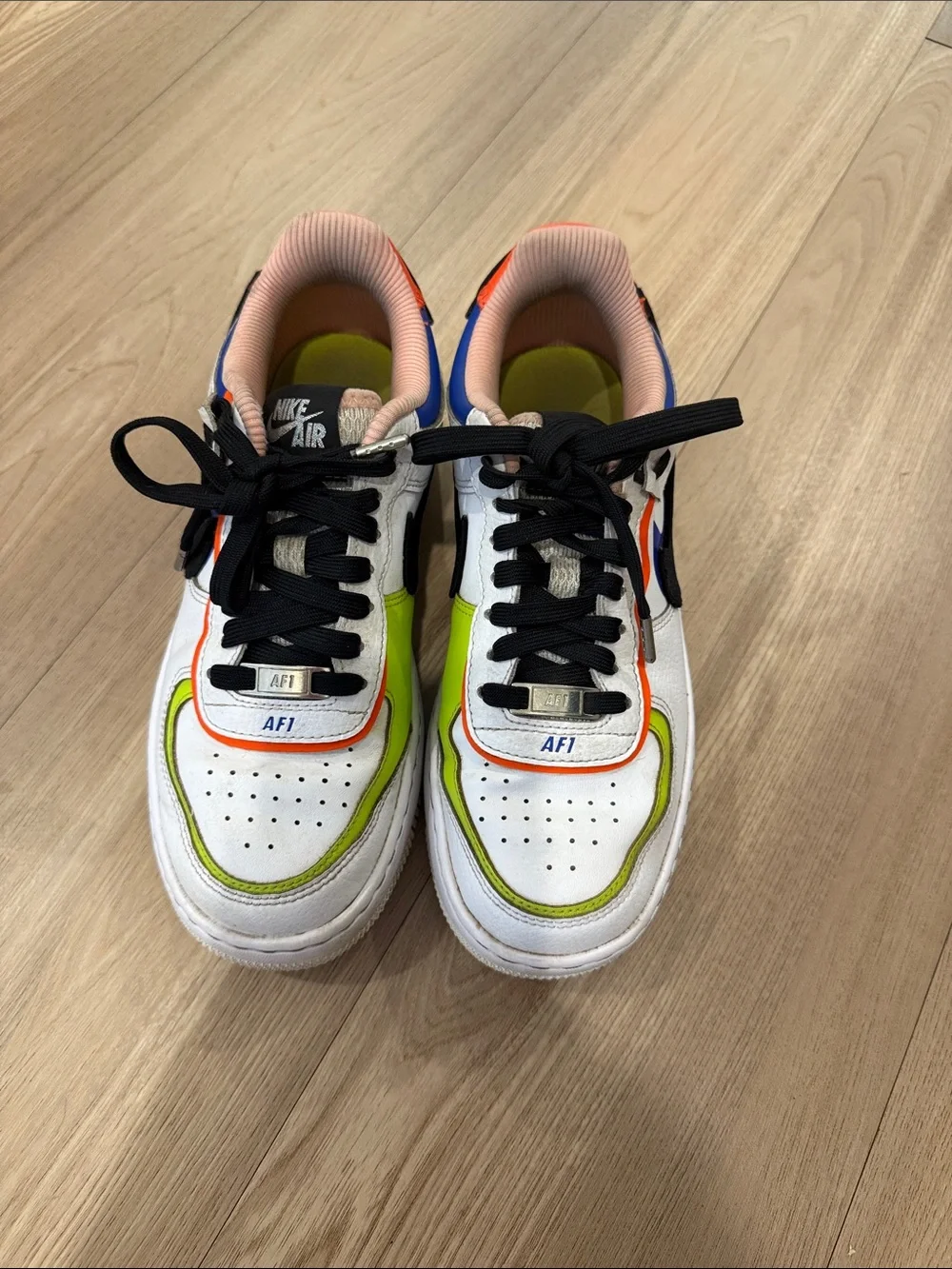 Nike White Low-Top Sneakers with Black Swoosh and Neon Green & Orange Accents